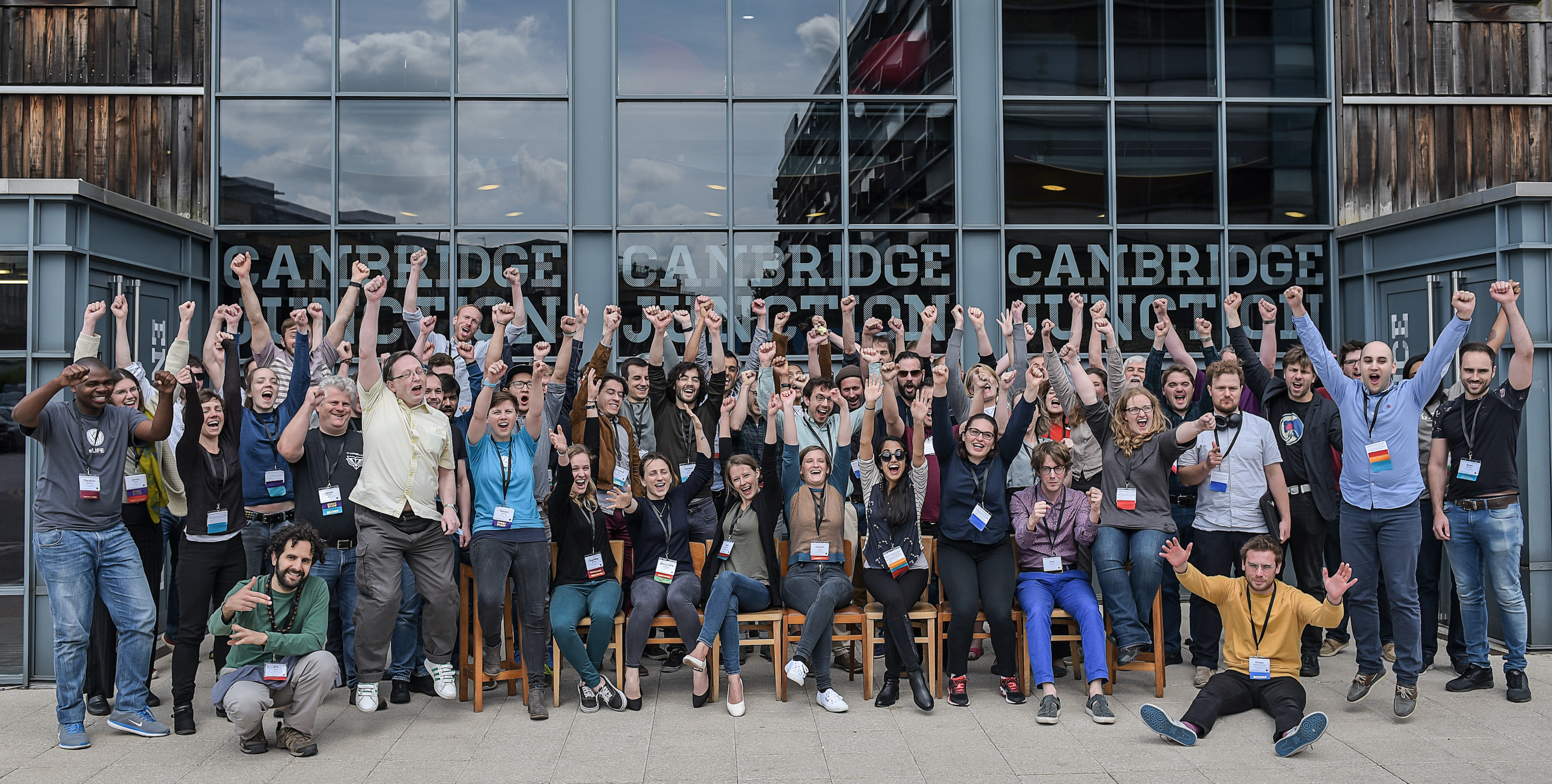 The 60 participants at the eLife Sprint 2018 celebrate with raised hands in a group photo